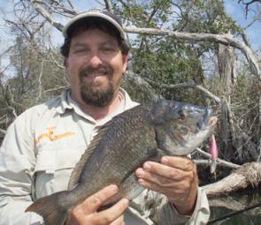 The author with a 42cm bream caught on a hard-bodied lure.